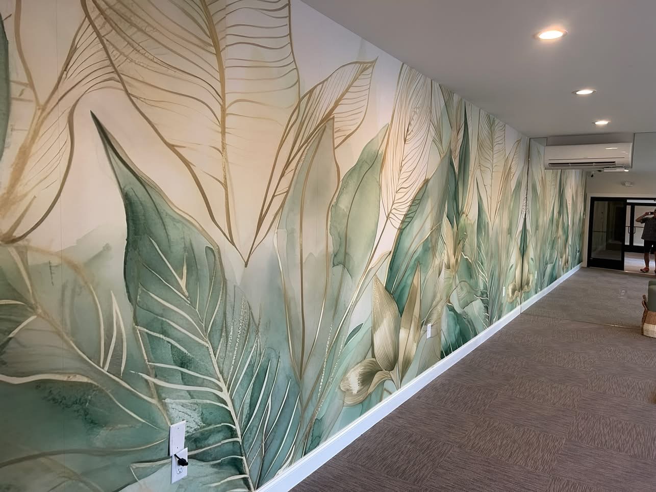 Beautiful botanical wallpaper installation in a modern hallway