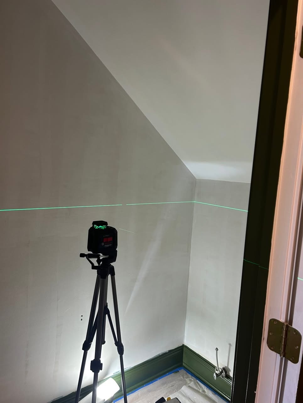 Laser level used for precise wallpaper alignment